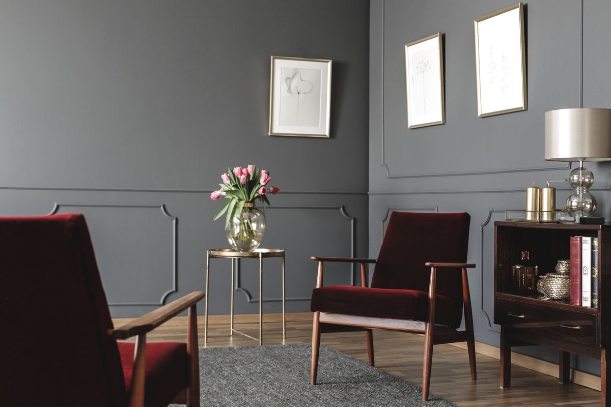 A warm, calming therapy room with comfortable armchairs and fresh flowers